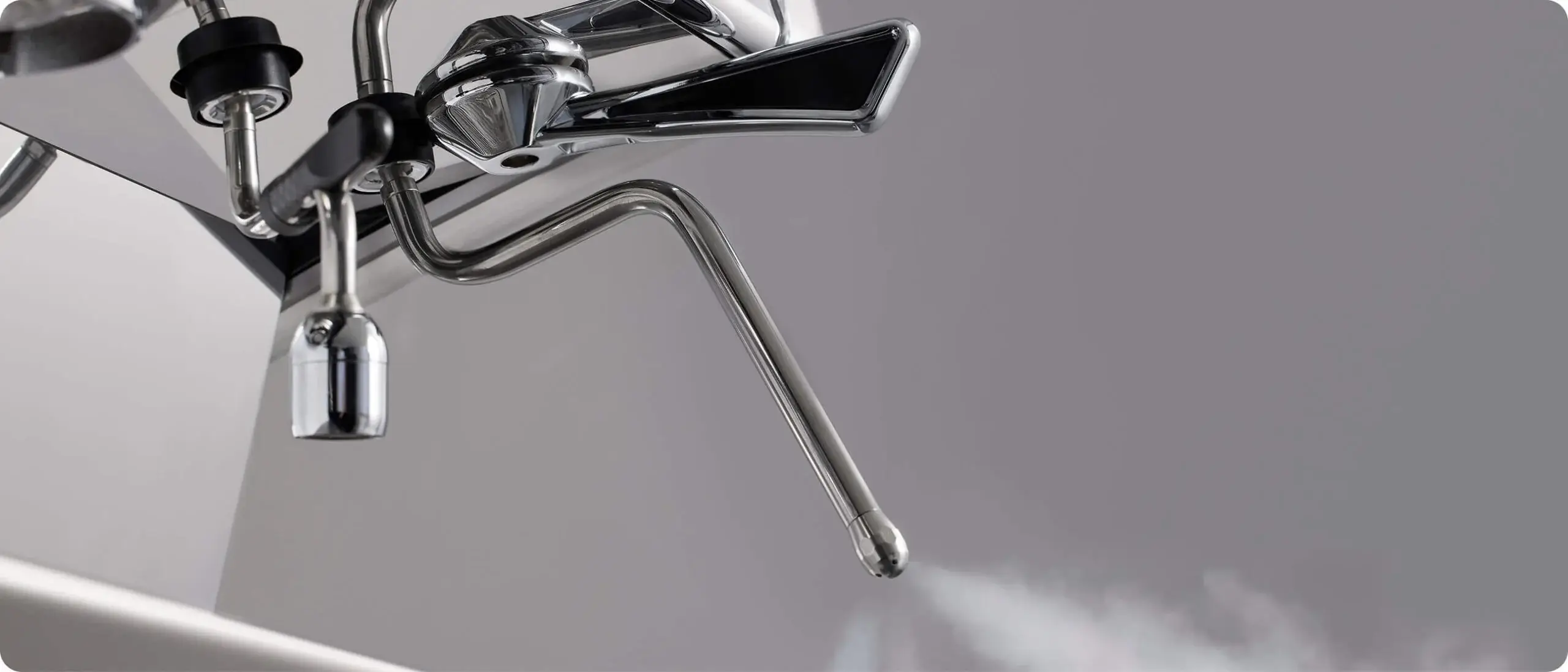 Close-up of the UNIC Stella Epic steam wand releasing steam